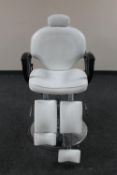 A Lotus hydraulic adjustable podiatrist's chair upholstered in white