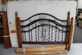 An iron and pine 4'6 bed frame with memory foam interior