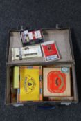 A case containing playing cards, cigar packets and boxes,