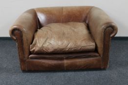 A tan leather oversized armchair