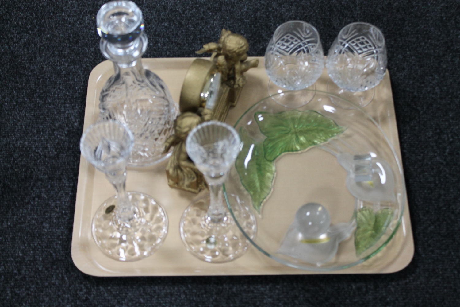 A tray of cherub mantel clock, lead crystal decanter, pair of RCR crystal candlesticks,