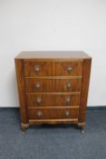 A mid 20th century walnut four drawer chest