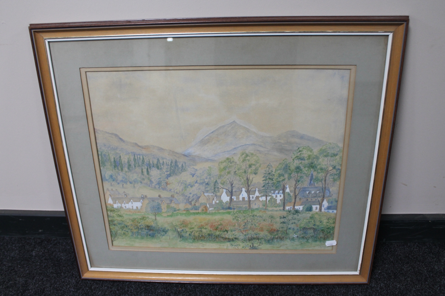 A framed watercolour depicting rural village scene