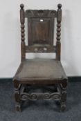 A late 18th/19th century heavily carved oak hall chair