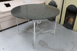 A circular marble topped patio table on a painted metal base