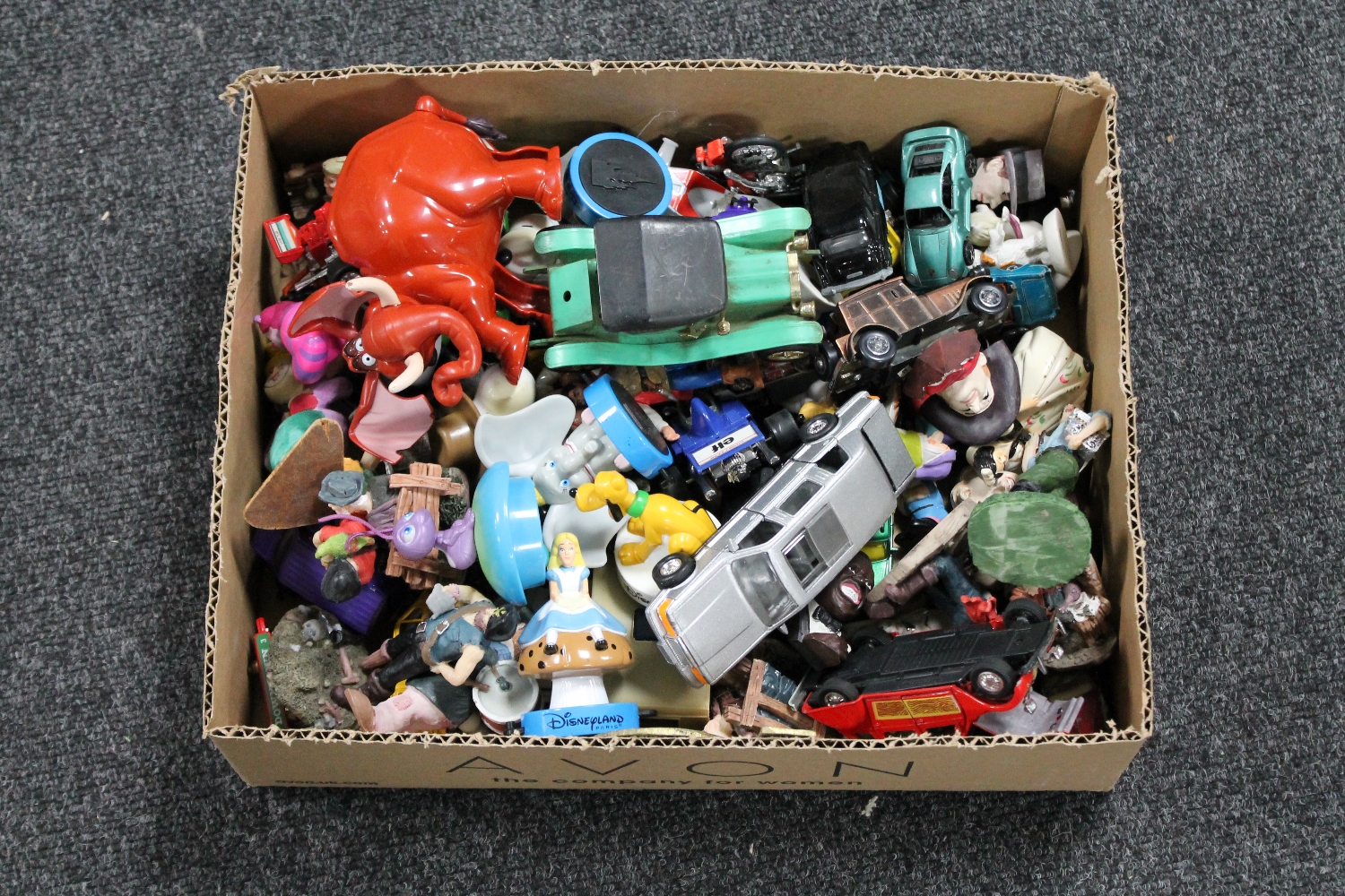 A box of die cast vehicles, fridge magnets,