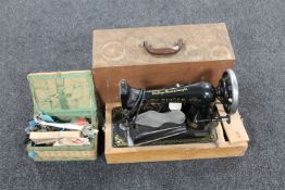 A mid 20th century cased Singer electric sewing machine and a sewing box with contents