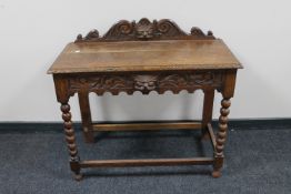 An early 20th century carved oak Gothic style hall table