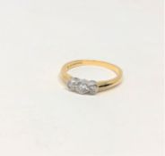 An 18ct gold three stone diamond ring, the stated total diamond weight 0.