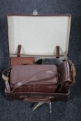 A vintage leather luggage case, antique field glasses,