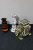 A glazed pottery elephant plant stand together with a floral pottery jardiniere stand and West