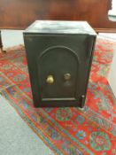 An antique metal fire safe with key, width 54 cm.