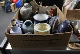 A box of studio pottery items including vases, wall masks,