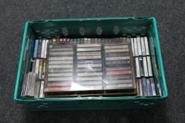 A crate and storage box of cassette tapes 1970's etc