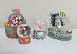 Four Disney snow globes : Mickey and Minnie,