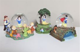 Three Disney snow globes : Snow White and the seven Dwarfs