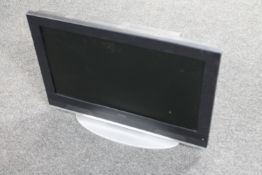 A Goodman's 26" LCD TV with box containing assorted leads and remotes