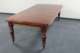 A Victorian mahogany extending dining table fitted three leaves