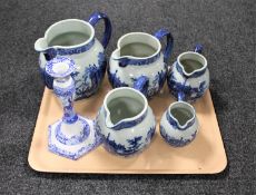 A tray of five blue and white ironstone graduated jugs and a Copeland Spode Italian candlestick