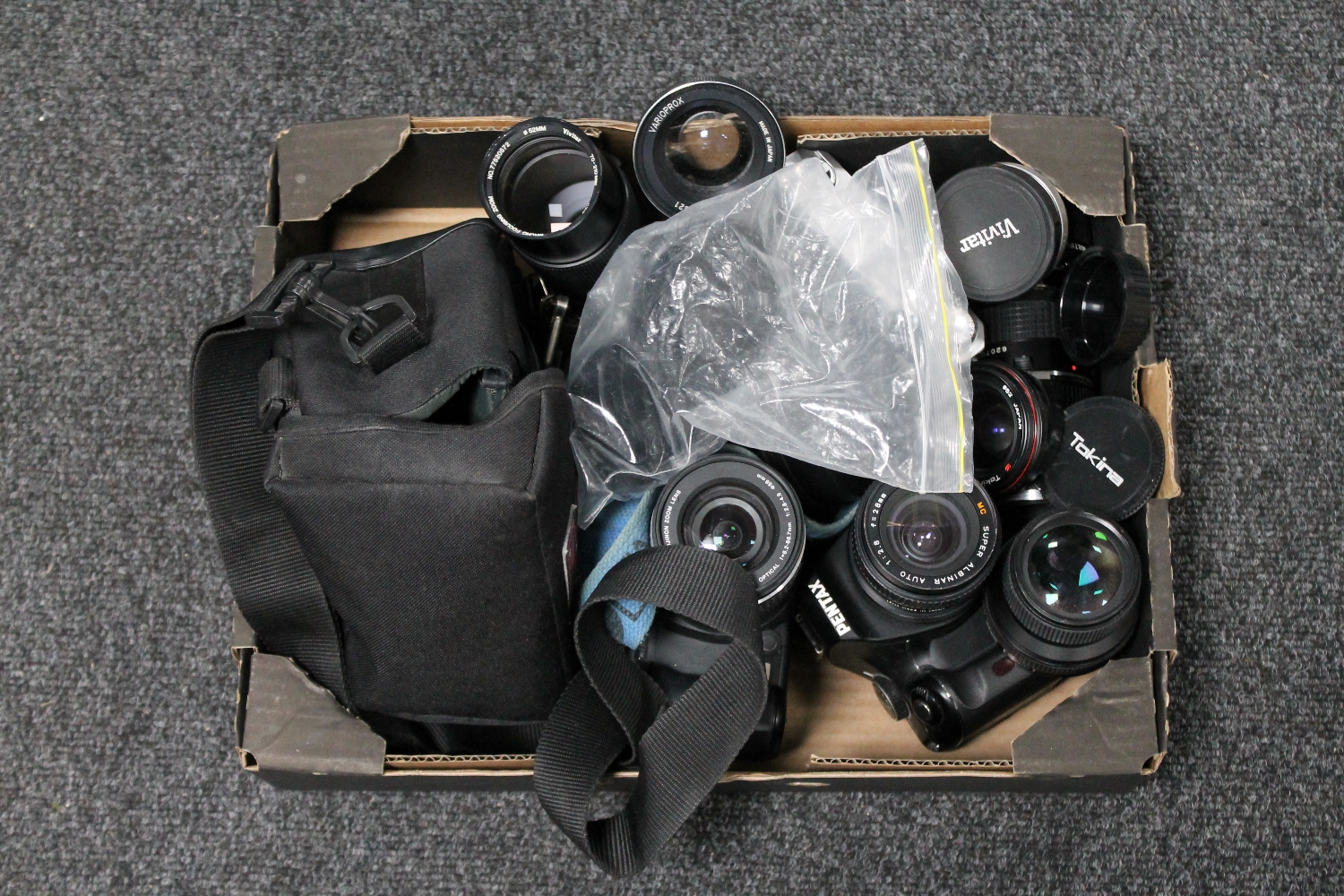 A box of four cameras : Minolta etc and a quantity of camera lenses