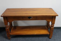 A Mexican pine two tier side table fitted with a drawer