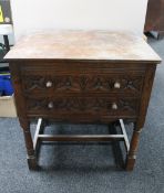 A Jacobean style oak side table fitted with two drawers