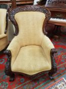 A pair of heavily carved Victorian style armchairs,