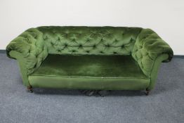 An antique Chesterfield style settee upholstered in green buttoned dralon