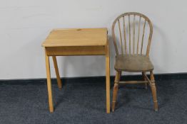 A mid 20th century child's school desk together with a kitchen chair