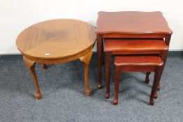 A 1930's circular mahogany coffee table on claw and ball feet together with a nest of tables