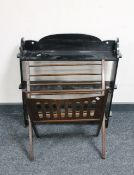 A carved ebonised three tier wall shelf together with a mid twentieth century folding magazine rack