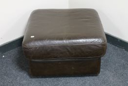 A brown leather footstool