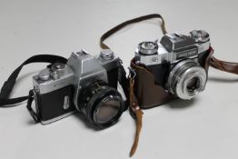 A Zeiss Ikon Contaflex camera and an Olympus FTL camera