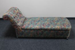 An antique pine chaise longue in floral fabric