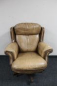 A 1970's swivel brown button leather captain's armchair