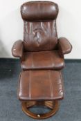 A brown leather adjustable reclining armchair with stool