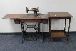 A treadle sewing machine walnut table and an occasional table