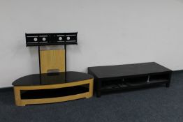 A contemporary glass topped TV stand together with a black ash two tier coffee table