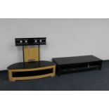 A contemporary glass topped TV stand together with a black ash two tier coffee table