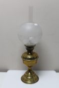 Three antique brass oil lamps with glass shades