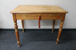 An antique pine kitchen table fitted a drawer