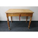 An antique pine kitchen table fitted a drawer