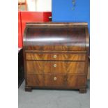 A late 19th century mahogany barrel fronted bureau