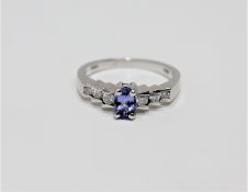 A 14ct white gold tanzanite and diamond ring, size N.