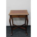 A mahogany occasional table on cabriole legs fitted with a drawer