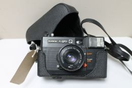 A Konica C35 EFP camera in case with 38mm lens