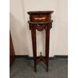 A reproduction ormolu mounted mahogany plant stand,