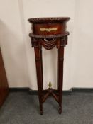 A reproduction ormolu mounted mahogany plant stand,