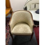 A mahogany framed tub chair upholstered in golden classical print