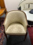 A mahogany framed tub chair upholstered in golden classical print